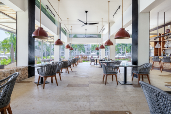 Waves restaurant, a casual dining area near pool with open layout and modern seating. Waves restaurant, a casual dining area near pool with open layout and modern seating.