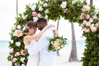 Couple getting married on the beach at Hyatt Zilara Cap Cana with floral arch and ocean backdrop in Punta Cana Dominican Republic destination wedding resort Couple getting married on the beach at Hyatt Zilara Cap Cana with floral arch and ocean backdrop in Punta Cana Dominican Republic destination wedding resort