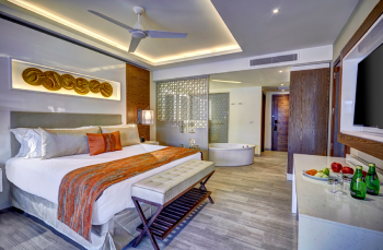 Royalton Bavaro junior suite interior with king bed, soaking tub, modern decor, and luxury amenities in Punta Cana Royalton Bavaro junior suite interior with king bed, soaking tub, modern decor, and luxury amenities in Punta Cana