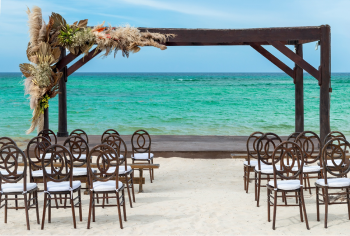 Beach wedding ceremony setup at the resort with chairs and oceanfront view on Bavaro Beach Beach wedding ceremony setup at the resort with chairs and oceanfront view on Bavaro Beach