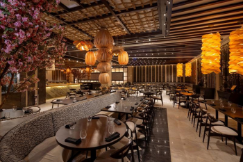 Modern Asian restaurant with decorative lighting, sushi bar, and contemporary dining space.