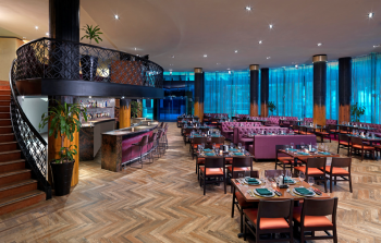 Modern steakhouse restaurant interior with bar seating and upscale dining atmosphere at Toro