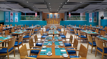 Contemporary Mexican restaurant with colorful décor and table settings at Frida