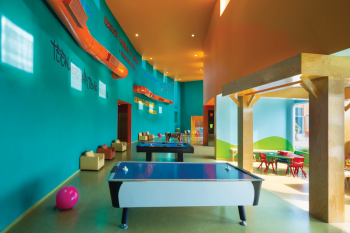 Kids club play area with games, tables, and colorful seating designed for children