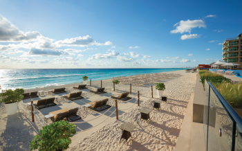 Beachfront lounge area with sunbeds and ocean views at Hard Rock Cancun
