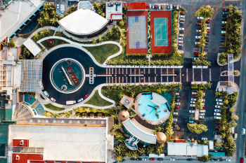 Aerial view of resort layout with pool, tennis courts, and surrounding property in Cancun