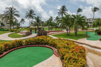 Mini golf course surrounded by tropical landscaping at Moon Palace Cancun resort in Mexico. Mini golf course surrounded by tropical landscaping at Moon Palace Cancun resort in Mexico.