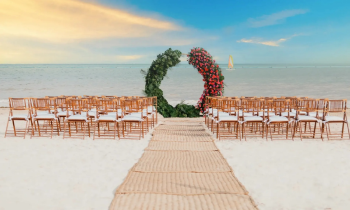 Oceanfront wedding ceremony setup on the beach at Moon Palace Cancun with chairs and floral ceremony arch overlooking the water. Oceanfront wedding ceremony setup on the beach at Moon Palace Cancun with chairs and floral ceremony arch overlooking the water.