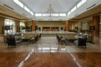 Spacious lobby at El Dorado Royale
featuring elegant seating areas, high ceilings, marble floors, and contemporary
design in an adults-only Riviera Maya resort. Spacious lobby at El Dorado Royale
featuring elegant seating areas, high ceilings, marble floors, and contemporary
design in an adults-only Riviera Maya resort.