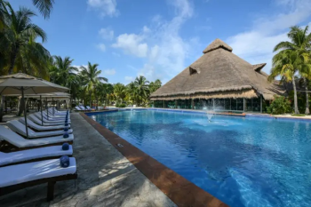 Resort pool surrounded by tropical
landscaping, lounge chairs, and a palapa-style gathering space at El Dorado
Royale in Mexico. Resort pool surrounded by tropical
landscaping, lounge chairs, and a palapa-style gathering space at El Dorado
Royale in Mexico.