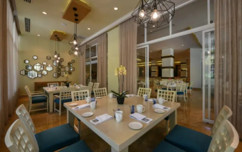 Dining room at Cocotal restaurant featuring contemporary décor and indoor seating for guests enjoying
breakfast and dinner during their stay. Dining room at Cocotal restaurant featuring contemporary décor and indoor seating for guests enjoying
breakfast and dinner during their stay.