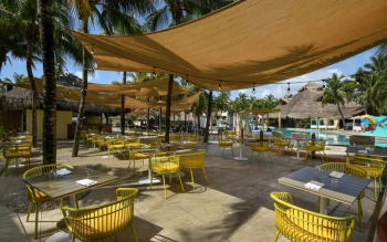 Outdoor seating area at La Cabaña Pizzería overlooking the pool, offering casual dining in a
tropical setting. Outdoor seating area at La Cabaña Pizzería overlooking the pool, offering casual dining in a
tropical setting.