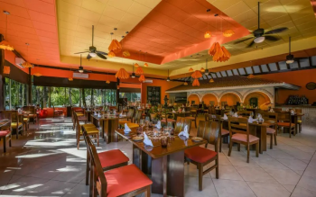 Dining room at Rincón Mexicano featuring
warm décor and traditional Mexican restaurant design. Dining room at Rincón Mexicano featuring
warm décor and traditional Mexican restaurant design.
