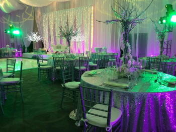 Reception setup inside Salon Royale
featuring specialty lighting, formal dining tables, and wedding décor. Reception setup inside Salon Royale
featuring specialty lighting, formal dining tables, and wedding décor.