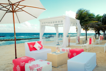 Beachfront wedding gazebo with lounge furniture
and ceremony décor by the ocean. Beachfront wedding gazebo with lounge furniture
and ceremony décor by the ocean.