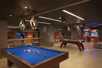 Billiards table and arcade games inside the Core Zone teens club at Dreams Playa Mujeres