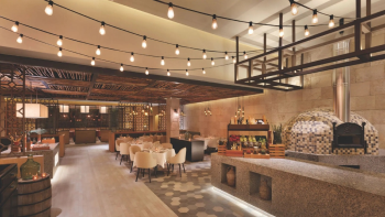 Lorenzo's Italian restaurant at Hyatt Ziva Cancun with string lighting, a wood-fired pizza oven, and trattoria-style seating