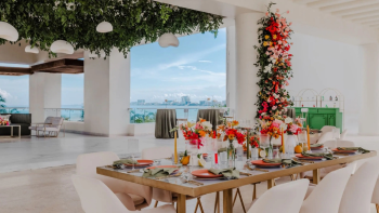 Sky Terrace at Hyatt Ziva Cancun set up for a wedding dinner with floral arrangements and ocean views