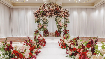 Elements Ballroom at Hyatt Ziva Cancun decorated with a floral wedding arch and aisle for an indoor ceremony